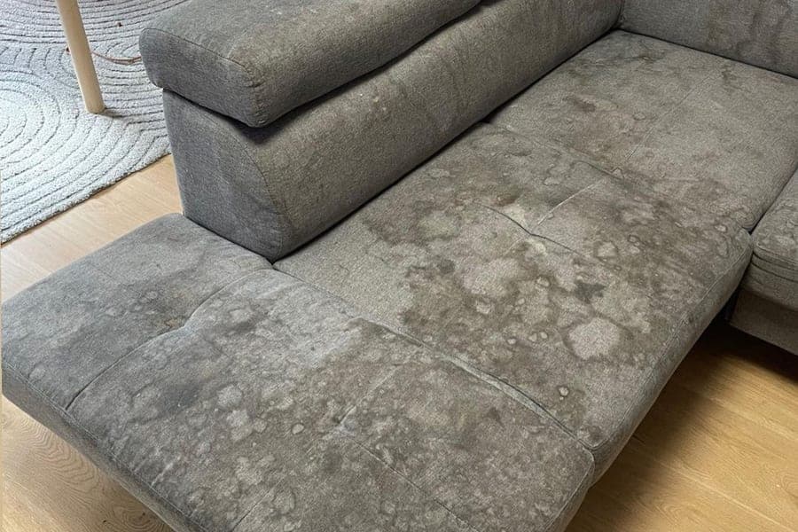 Dirty L-shape sofa before professional steam cleaning in Silvassa