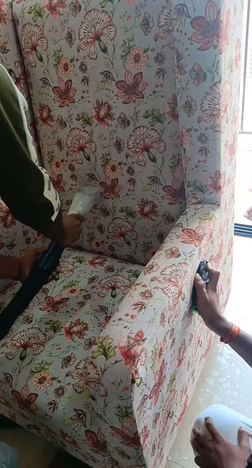 High-power hot-water extraction of a fabric armchair by Steam Car Spa's doorstep team